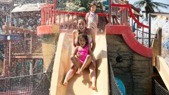Family on Caribbean Cove pirate ship slide