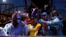 College student riding roller coaster with zombies at Fright Fest