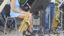 Instruments on stands with musicians sitting