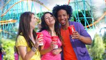 guy and girls standing in front of a coaster