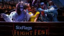 A group of scary ghouls riding a swinging ship with a screaming girl, full moon and roller coaster in background.