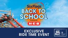 blue sky with people riding coaster with hands up