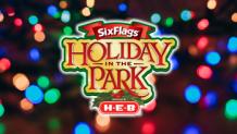 holiday in the park presented by H E B logo over faded rainbow Christmas lights