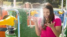 Guest getting splashed on Bucket Blasters at Six Flags Great Escape and Hurricane Harbor