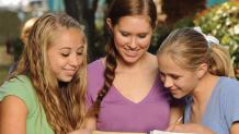 Group of girls reading in the park