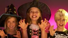 Kids trying to be scary over carved pumpkins at The Great Escape.