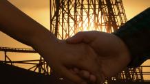 two people holding hands in front of a coaster