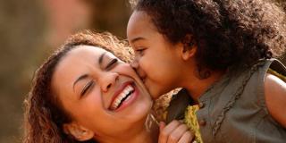 Daughter kissing Mother's cheek