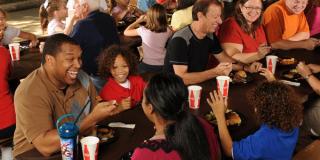 Large group eating at picnic tables