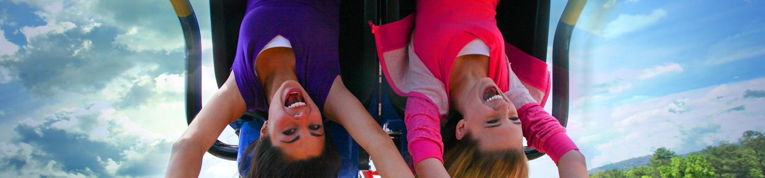 two passengers upside down on a roller coaster